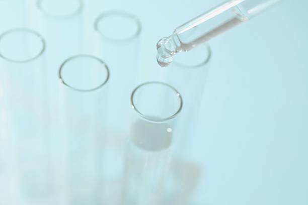istock Test tubes with different illustrations of DNA in laboratory, closeup 2247435488