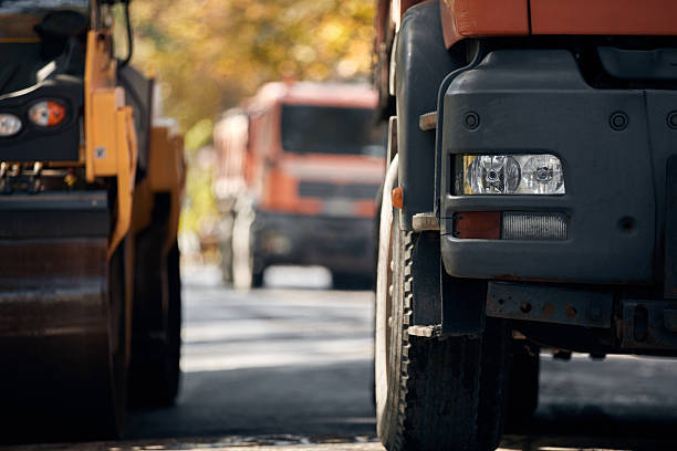 istock Public city street reconstruction with heavy machines. 2247435682