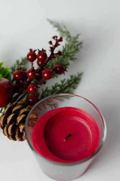 red candle with a Christmas tree branch