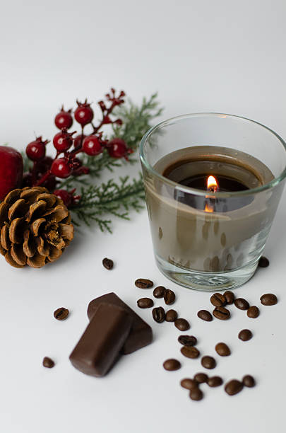 istock burning candle with a Christmas tree branch in coffee beans and with chocolate candies 2247437549
