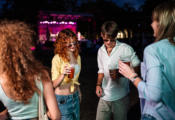 istock Young adults enjoying festival night with drinks 2247438071