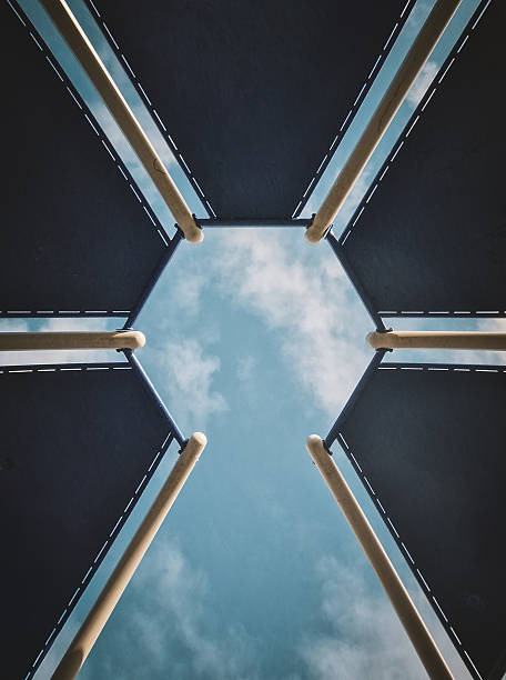 Construction frame on a building with a b sky in the background.