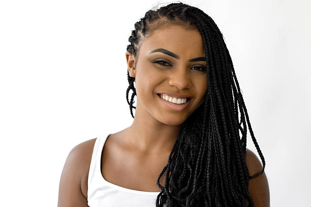 Pretty young black female posing against white background