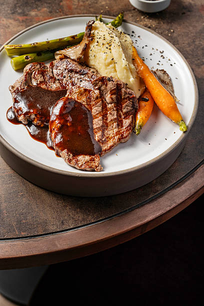 Traditional steak and mashed potatoes. Beef steak with potato mash and roasted vegetables.