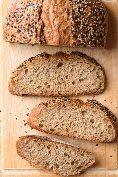Healthy vegan dark rye sourdough bread topped with sesame and flaxseed