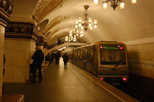 Subway train departing from the station, locomotive and wagons, people on the platform, busy city life, pubic transport, Moscow metro station