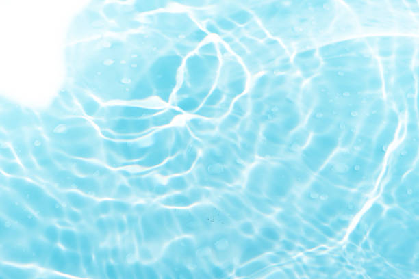 istock Blue water with ripples on the surface. Defocus blurred transparent blue colored clear calm water surface texture with splashes and bubbles. Water waves with shining pattern texture background. 2247443233