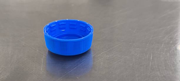 istock A blue soda bottle cap sits on a stainless steel table. 2247449020