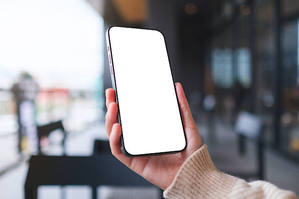 istock Mockup image of a woman holding and using mobile phone with blank desktop screen in cafe 2247450603