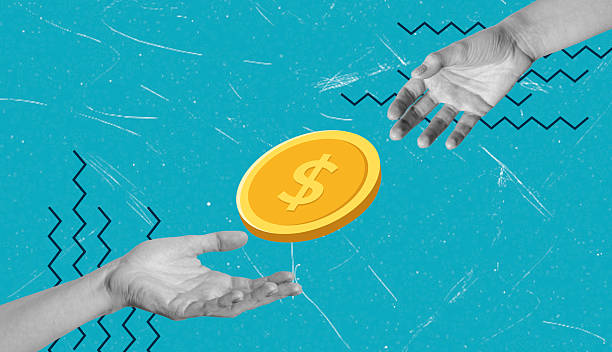 istock Hands exchanging a coin against a vibrant blue background showcasing financial transaction concept 2247450804