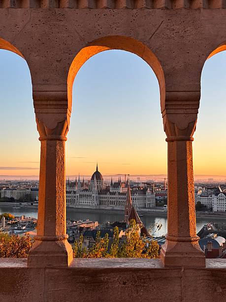 A peaceful sunrise illuminating Fisherman’s Bastion in Budapest. The soft morning light highlights the white stone towers and terraces, creating a magical and serene atmosphere over the city.