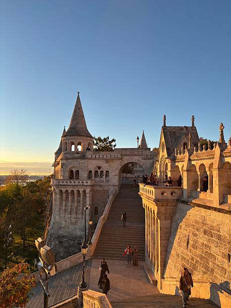 A peaceful sunrise illuminating Fisherman’s Bastion in Budapest. The soft morning light highlights the white stone towers and terraces, creating a magical and serene atmosphere over the city.