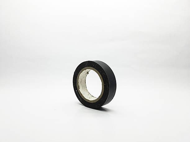 istock Roll of black electrical tape standing upright on a white background 2247451394