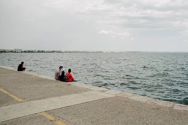 Thessaloniki, Greece. May 24, 2018. Image detraying a stretch of the seafront of the Greek city of Thessaloniki on a spring day. Thessaloniki, located in the northern part of Greece, is an important historical city for its geographical location and the events that have affected it over the centuries. Among other things, Thessaloniki was home to one of the most important Jewish communities in Europe and today is a destination for thousands of visitors and tourists throughout the year. In this photo you can see some people walking along the water's edge