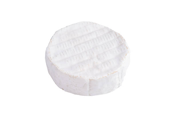 istock Whole round soft cheese with a white bloomy rind captured on a clean light background for a minimal fresh food aesthetic. 2247451859