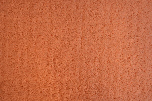 A highly detailed close-up photograph showcasing a textured surface composed of small, gray, sand-like fibers of carpet