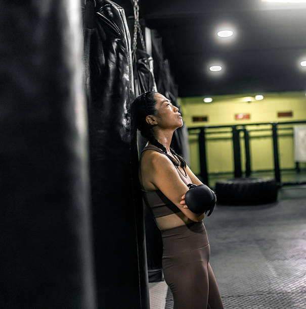 japanese  woman taking a break during boxing workout