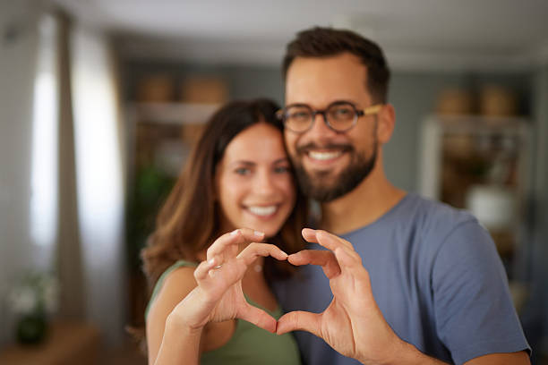 istock Happy adult couple forming heart shape with hands 2247457537