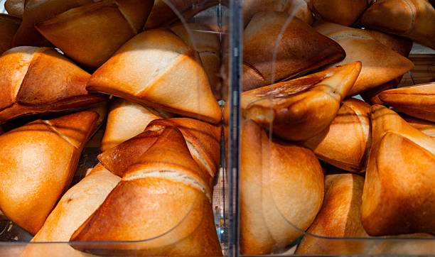 istock Freshly baked pastries arranged neatly in a display case at a bakery showing a variety of golden-brown shapes and textures tempting customers 2247458572