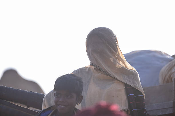 Pushkar, Rajasthan, India - November 2024: Portrait of an unidentified Indian rajasthani woman in colorful traditional dress at Pushkar Camel Fair ground during winter morning.