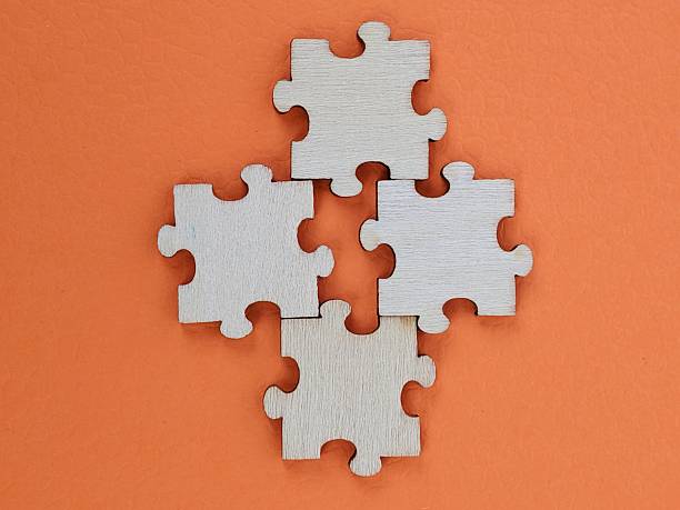 istock Puzzle pieces arranged in shape on orange background symbolizing teamwork, collaboration and creative problem solving 2247460282