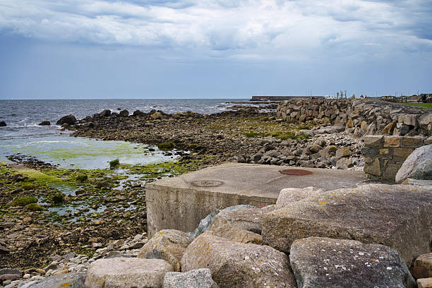 Coastal scene in Ireland featuring rocks, sea, and cloudy sky.