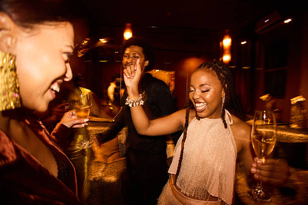istock Joyful young friends dancing and having fun together with champagne during a lively New Year’s Eve celebration 2247462171