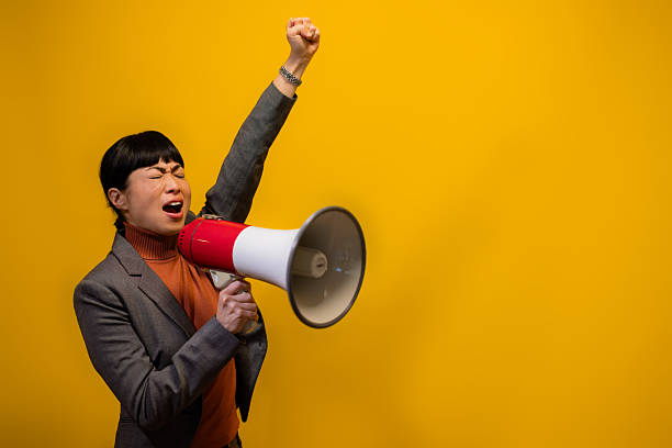 istock Determined Japanese speaker rallying with raised fist 2247462595