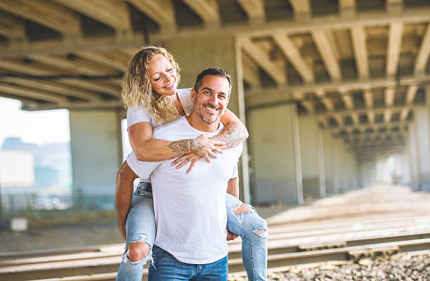 Latin heterosexual couple from Bogota Colombia between 30 and 34 years old, enjoy watching the rain while hugging at the rural hotel wearing casual clothes