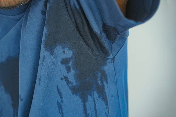 istock Sweat stains on blue shirt after intense workout session 2247465548