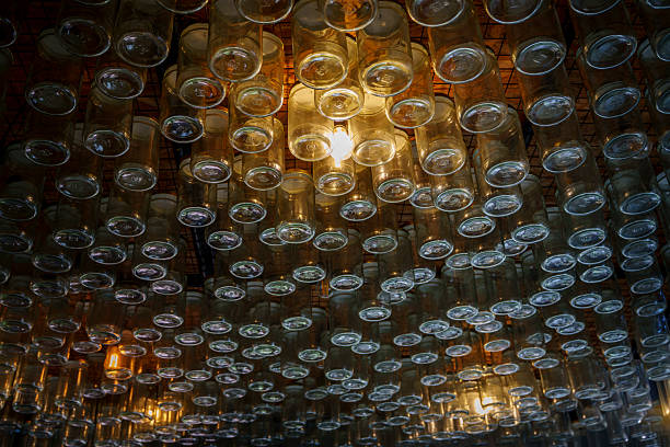 Ceiling art with hanging glass jars illuminates the room with creative, warm lighting.