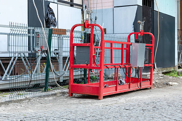 istock Red construction basket crane platform equipment at building site 2247467304