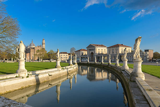 istock Prato della Valle is a large square in Padua, Italy, with a central elliptical island, surrounded by a canal and statues. 2247467341