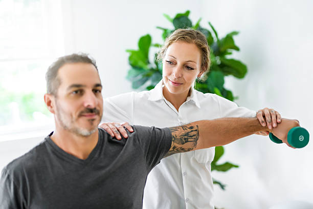 istock Modern rehabilitation physiotherapy woman with man client 2247467570