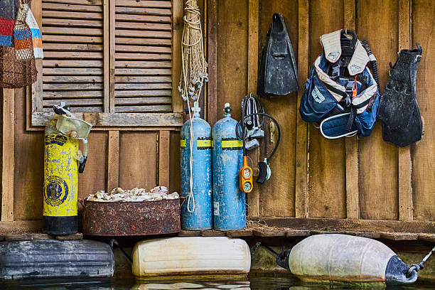 Weathered scuba gear in rustic shack, ready for underwater adventures on the coast.