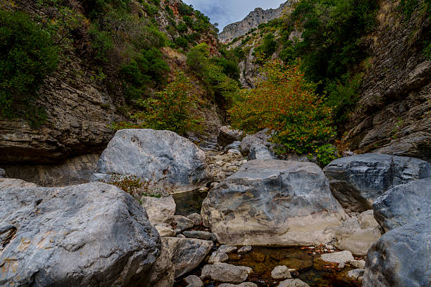 istock Boulder-filled gorge beneath steep limestone walls 2247468869