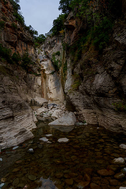 istock Dry waterfall amphitheater above clear stony pool 2247468928