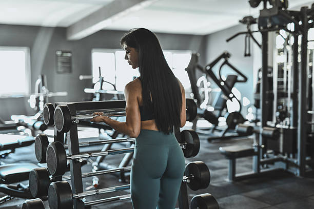 istock Fitness Enthusiast Lifting Weights In A Modern Gym For Strength And Training 2247469562