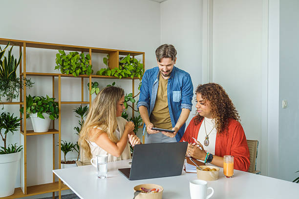 istock Diverse Team Engaging in Strategic Planning with Laptops and Tablets in Modern Office 2247469731