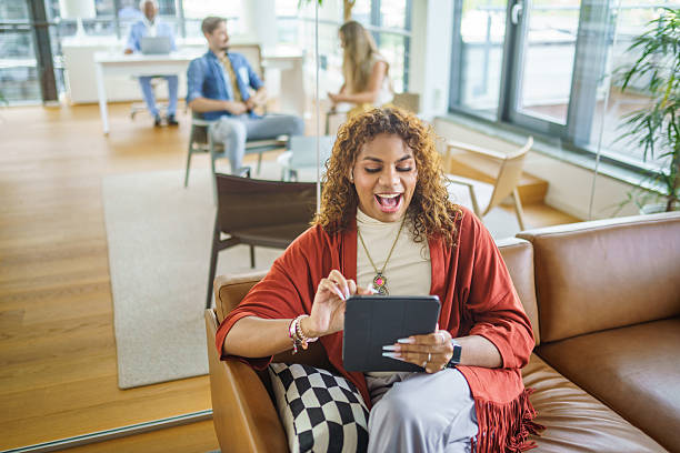 istock Young Hispanic Non Binary Professional Engaging Cheerfully in Video Call in Contemporary Office 2247469736