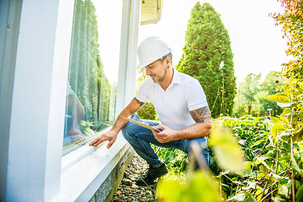 istock Man with a white hard hat holding a clipboard, inspect house window 2247469969