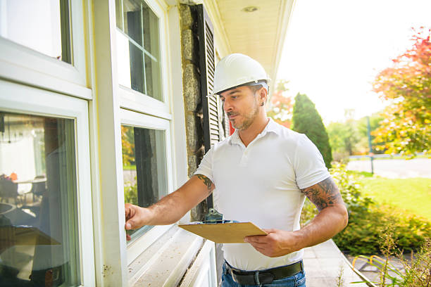 istock Man with a white hard hat holding a clipboard, inspect house window 2247469970