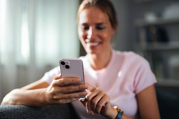 istock Smiling Woman Using Smartphone At Home Office For Casual Mobile Communication 2247474019