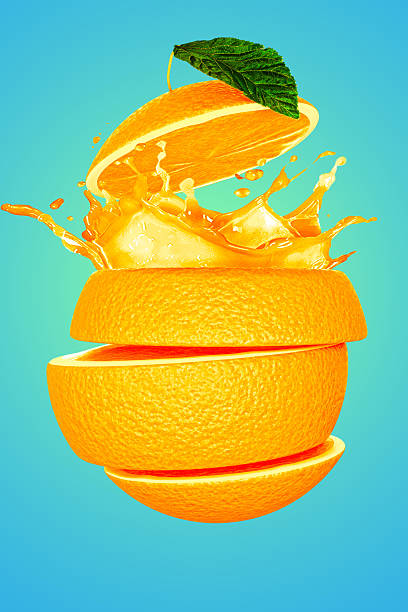 istock an orange being sliced with juice splashing out on blue background 2247474737