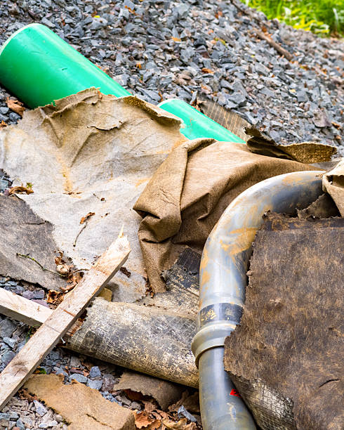 istock Construction waste polluting the environment with plastic pipes and roofing felt 2247474839