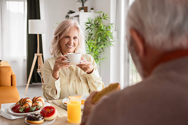 istock Relaxed Senior Couple Sitting Together with Coffee 2247477552