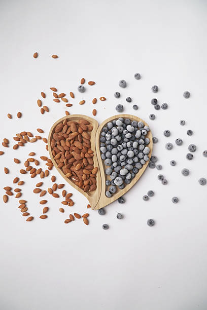Healthy Snack Concept with Blueberries and Almonds in a Heart-Shaped Wooden Bowl