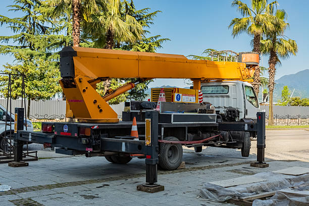 istock Yellow aerial lift truck working on construction site with palm trees 2247484468