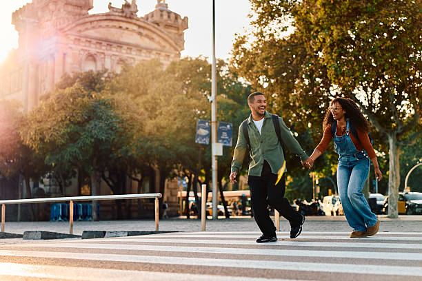 istock Happy black couple running holding hands on crosswalk 2247485523