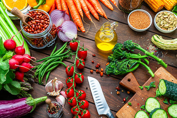 istock Fresh organic vegetables on kitchen table. Preparing healthy vegetarian meal, kitchen table filled with freshly picked. Food to improve the inmune system. Spices legumes and cooking oil 2247485824